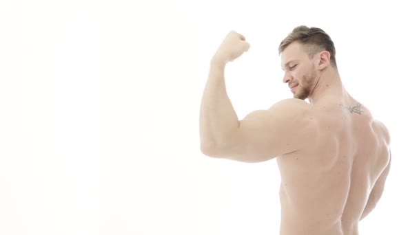 Kulturista protahuje svaly. Atlet ukazuje, biceps a mrknutí — Stock video