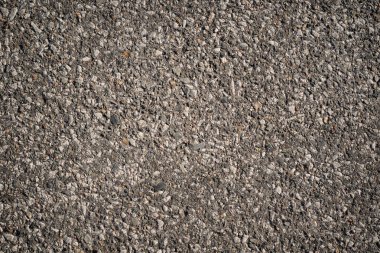 Çakıl taşlı eski kaba gri asfalt. yaratıcı sanat arkaplanı