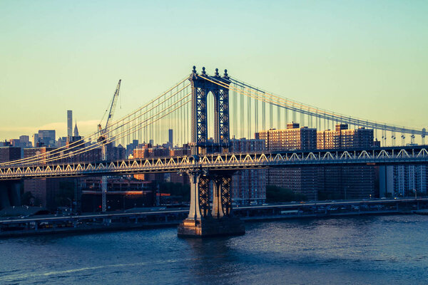 Manhattan bridge, the river and Manhattan city in vintage style, New York