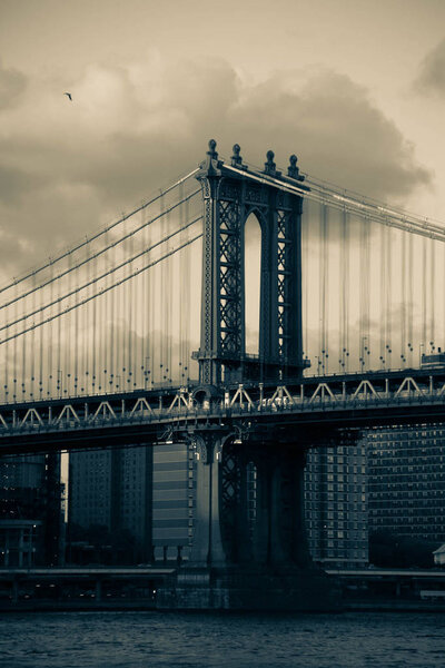 Manhattan bridge and the river in dark vintage style, New York