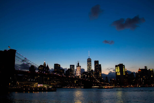 Light from buildings in Manhattan reflect on the river, New York