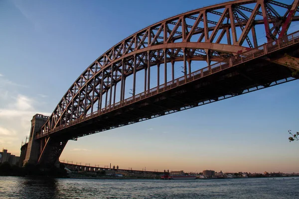 A Hell Gate híd a folyón, napnyugtakor ég, New York — Stock Fotó