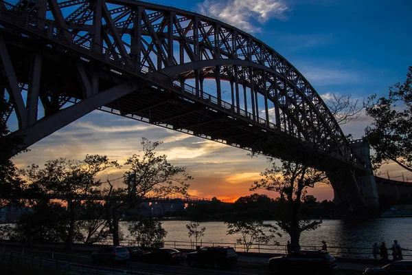 Hell Gate Bridge and in silhouette with sunset sky, New York — Stock Photo, Image