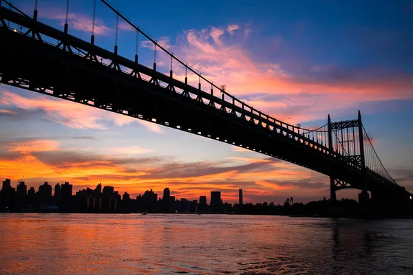 Silhouette der Triborough-Brücke über den Fluss und die Stadt Manhattan — Stockfoto