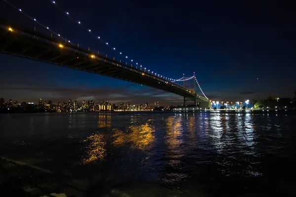 Ponte di Triborough sul fiume e luce dagli edifici di Manhattan di notte, New York — Foto Stock