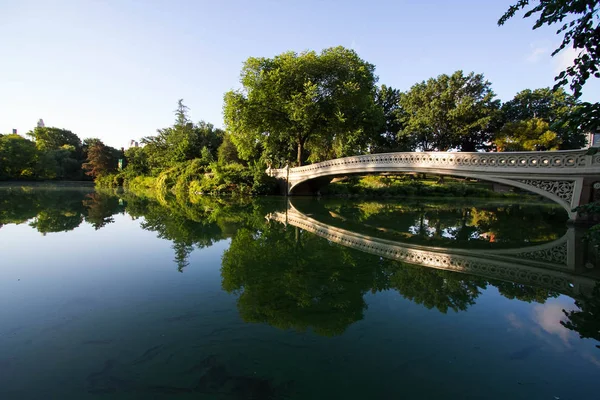 Ponte di prua riflette chiaramente sul lago a Central Park con cielo — Foto Stock