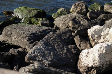 Gölge ve güneş ışığı ile kayalar ve su