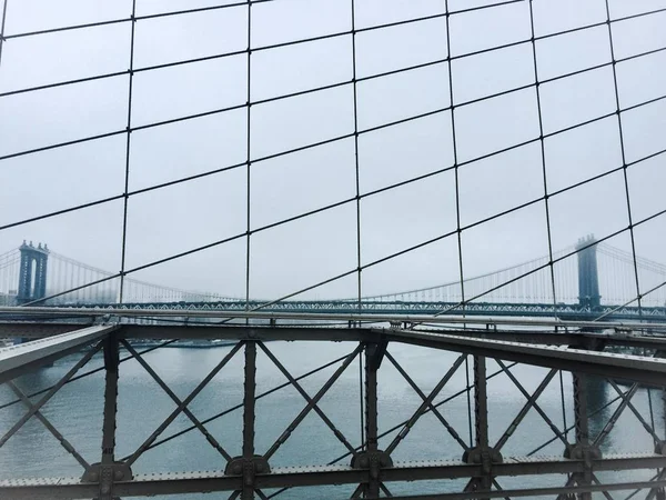 Manhattan and mist behind Brooklyn bridge's cable in vintage style — Stock Photo, Image