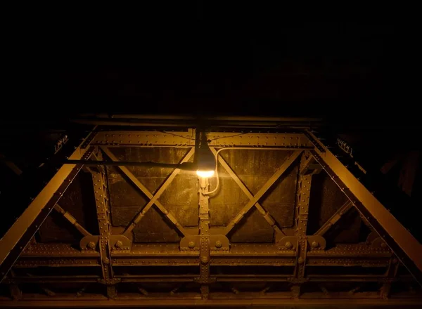 Metal structure with light bulb in the dark