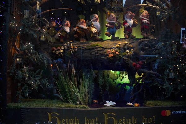 Manhattan, New York, December 20, 2017: seven dwarves on wood in Saks Fifth Avenues holiday window display; In celebration of the 80th anniversary of Disney's Snow White and the Seven Dwarfs