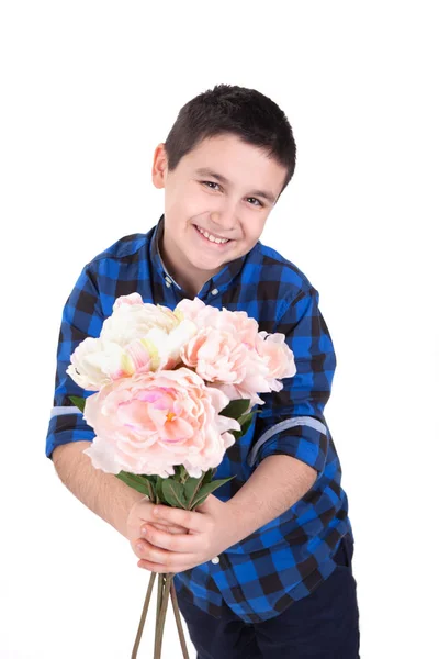 Portrait of a very happy young boy holding flowers, with white b — Stock Photo, Image