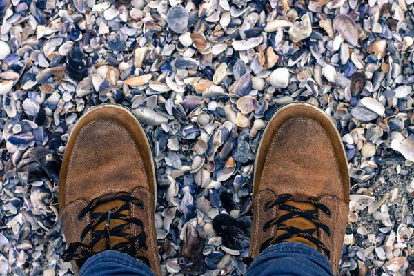 Boots on shells, view from above — Stock Photo, Image