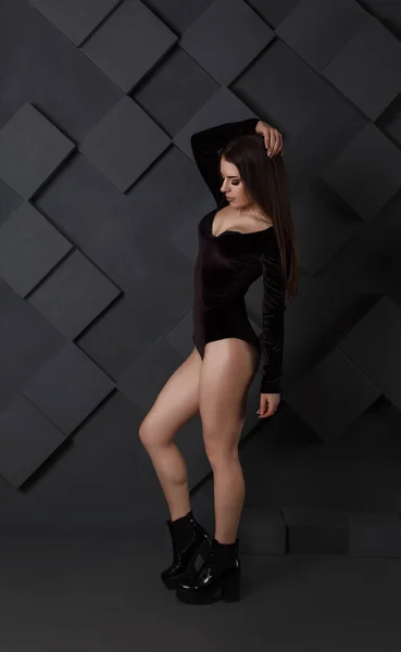sexy young woman in black bodysuit posing