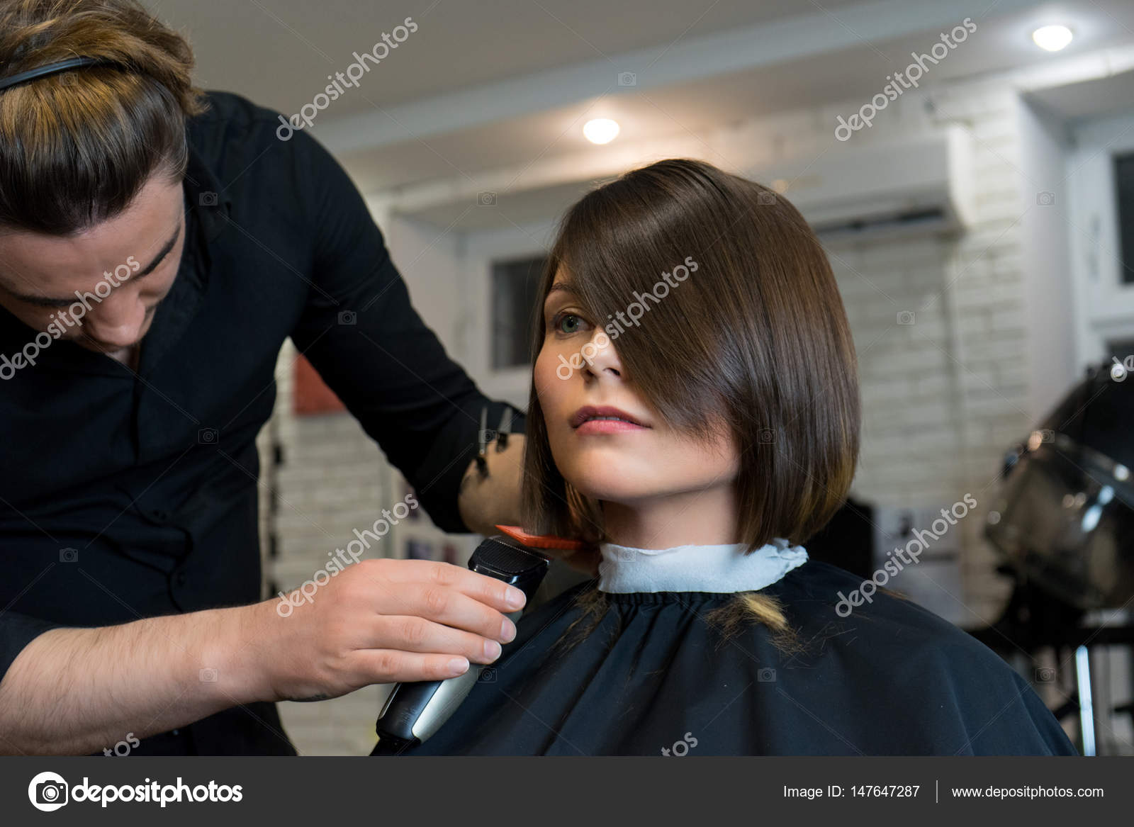 Male Hairdresser Does A Haircut To Pretty Woman Stock Photo