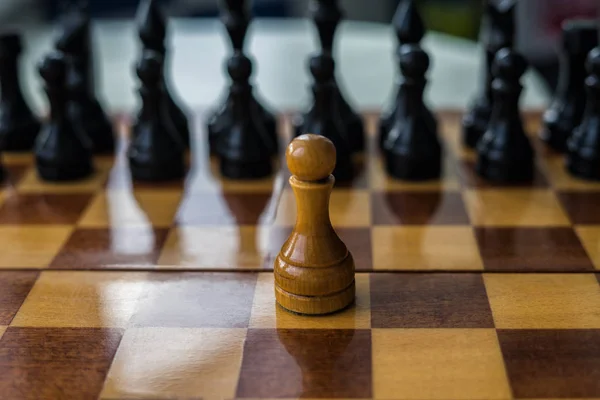 White chess pawn alone on a chessboard
