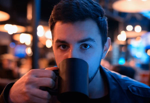 Joven bebiendo de la taza en la cafetería — Foto de Stock