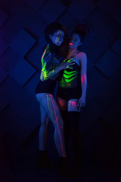 Sexy lesbian fashion models in uv neon light