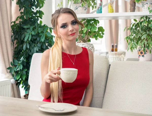 Affärskvinna dricka kaffe eller te i restaurangen. Damen i rött — Stockfoto