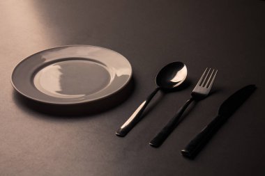 Boş tabak kaşıkla, bıçakla ve çatalla..