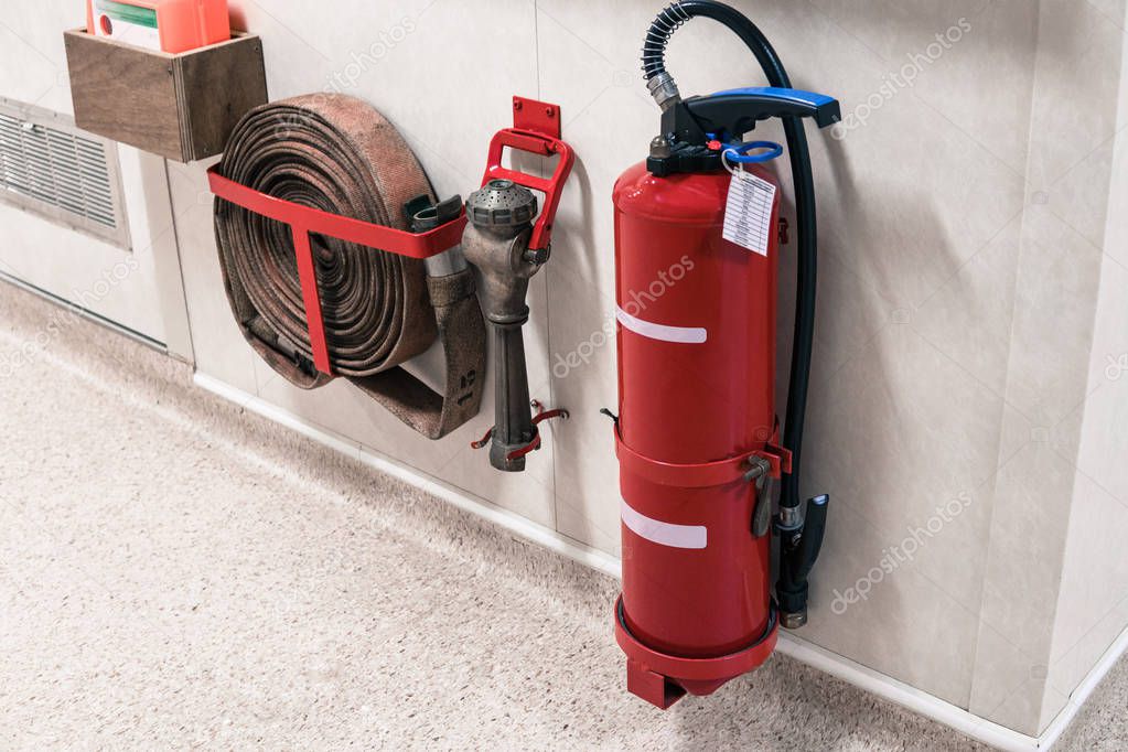 Fire extinguisher and fire hose reel in corridor