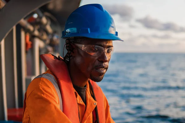 Seaman AB or Bosun on deck of vessel or ship , wearing PPE