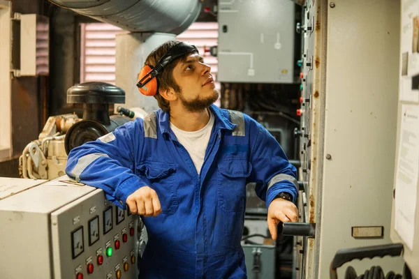 Marine engineer inspecting ships engine or generators