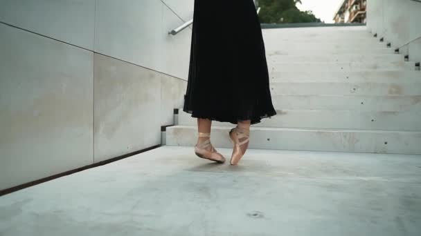 Young professional ballerina in black dress is dancing outdoors — 비디오