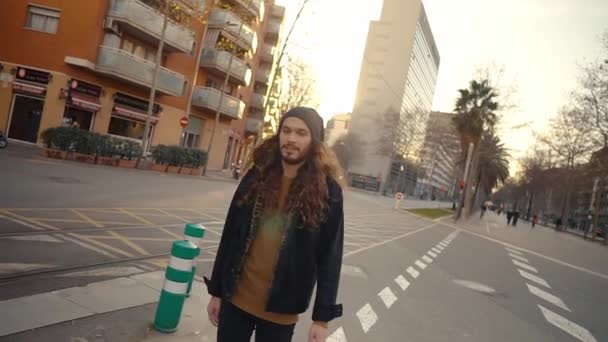 Portrait of long haired hipster walking on street in modern city — Stock Video