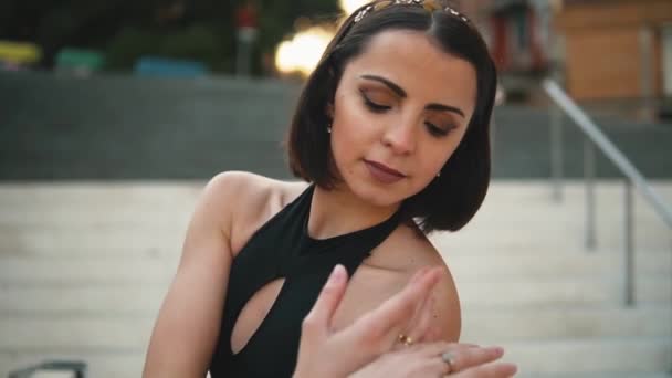 Young professional ballerina in black dress is dancing outdoors — Stock Video