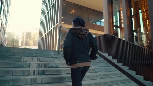 Portrait of long haired hipster walking on street in modern city — Stock Video