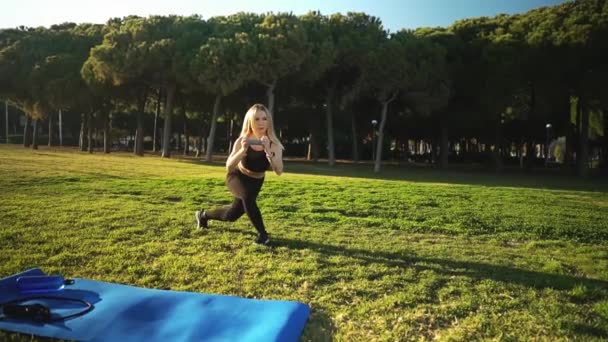 Entrenamiento deportivo en el parque urbano. Hermosa mujer caucásica en forma al aire libre — Vídeos de Stock