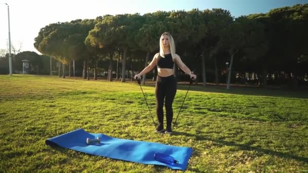 Trening sportowy w parku miejskim. piękne biały pasuje kobieta na zewnątrz — Wideo stockowe