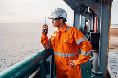 Filipino deck Officer on deck of vessel or ship , wearing PPE personal protective equipment clipart