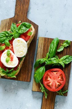 İtalyan aperatifi the Caprese Salatası ile mavi arka planda ahşap bir salata, İtalyan panini yakın görüntüsü - taze malzemelerle.