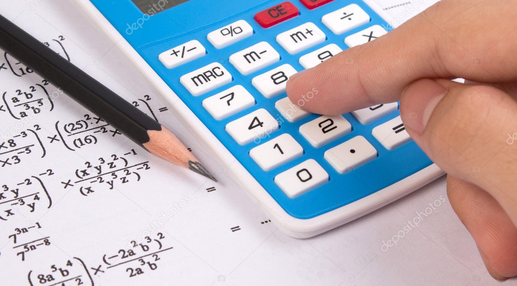 Hand press calculator on mathematical or math equations.