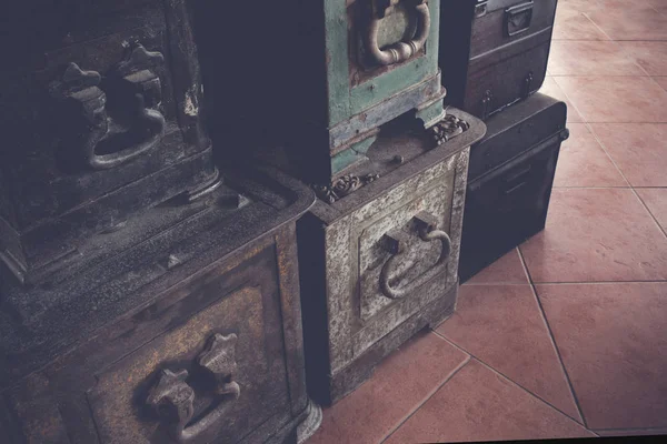 Old antique iron and wood travel chest in a stack used in the past with toned image as vintage background. — Stock Photo, Image