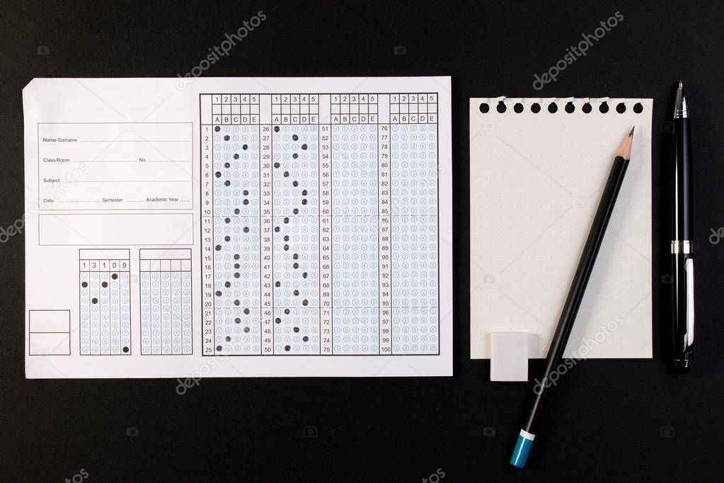 School exam answer sheet and pen. Standard test form or answer sheet. Answer sheet focus on pencil. Bubble answer sheet with blank answer.