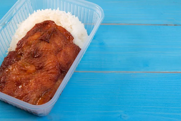 School lunch box rice and roast chicken in transparent box. Box lunch delivery service or take home lunch box.