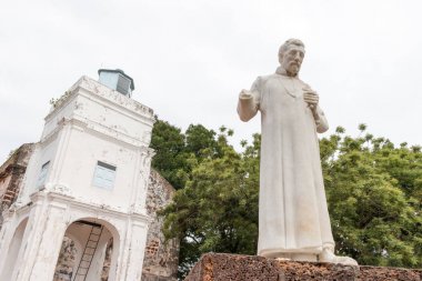 Statue of Saint Francis Xavier in outside of the church in front of the church of Saint Paul in the malay city of Malacca, Malaysia. clipart