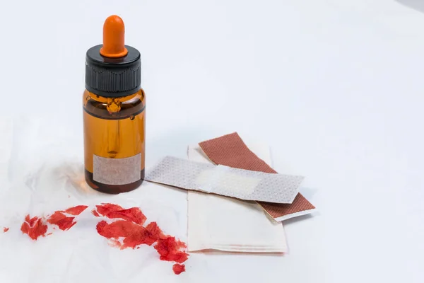 Fresh bleeding wounds or blood on tissue paper with first aid supplies, first aid equipment or emergency medical products.