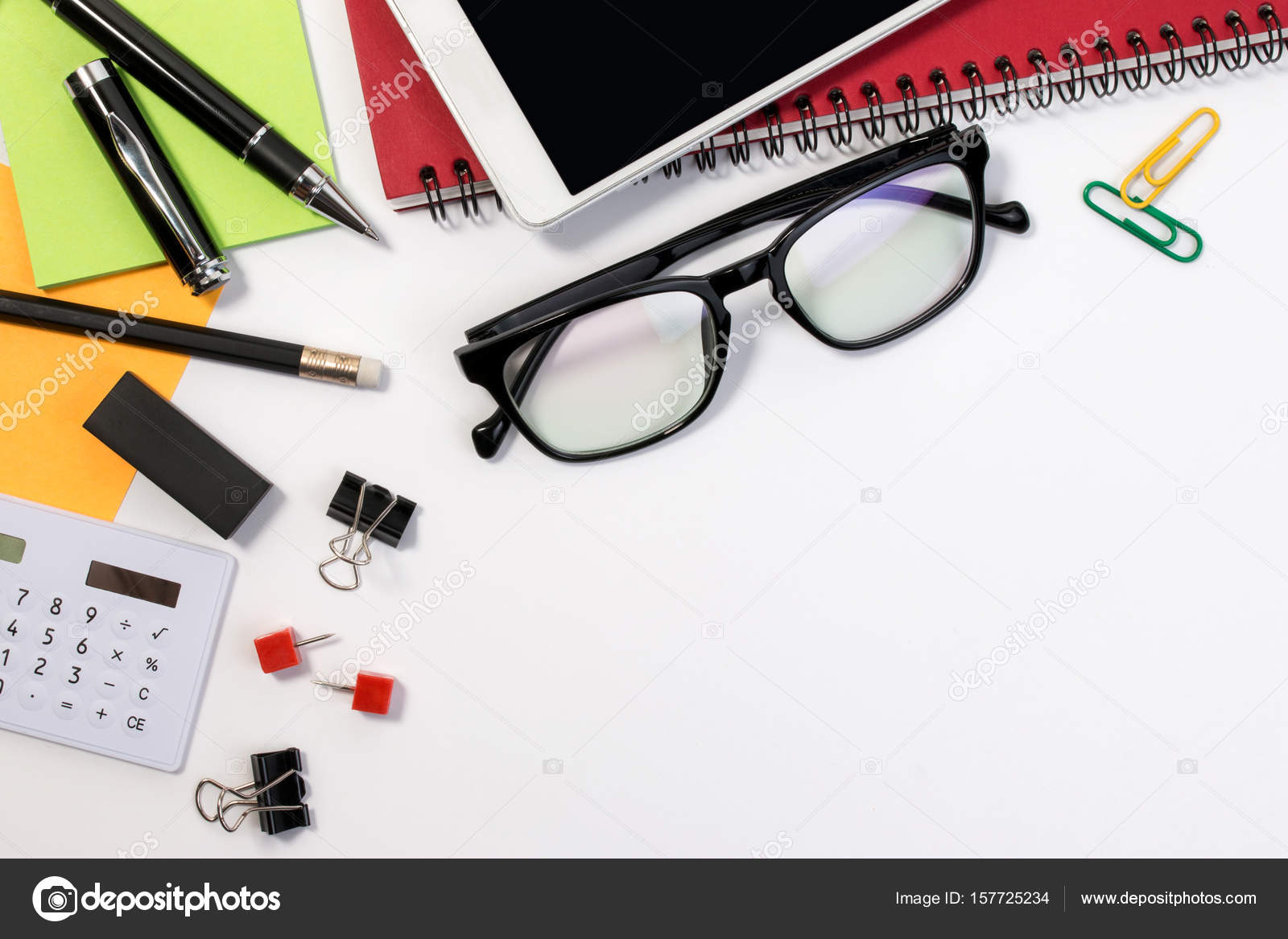 Business office desk table with office supplies and glasses with copy  space. White office business desk with a lot of supplies on white  background with blank space for text. Stock Photo by ©