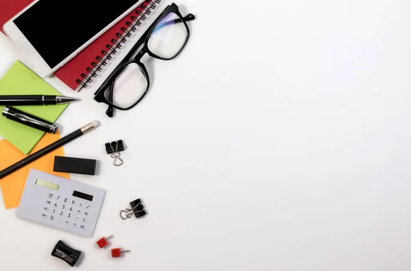 Business office desk table with office supplies and glasses with copy space. White office business desk with a lot of supplies on white background with blank space for text. — Stock Photo, Image