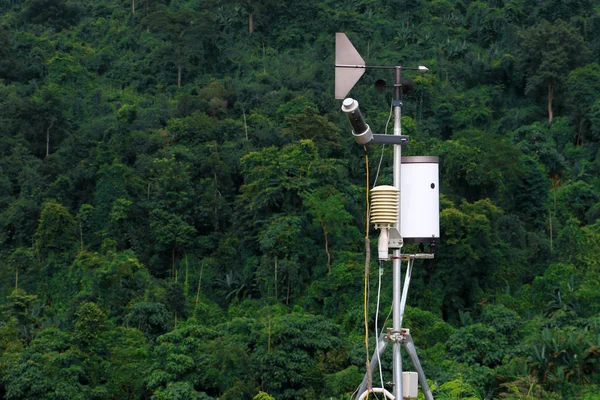 Antenna of meteorological weather station with meteorology sensors and forest in background. Weather station for background.