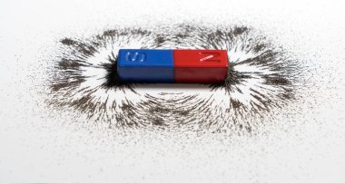 Red and blue bar magnet or physics magnetic with iron powder magnetic field on white background. Scientific experiment in science class in school. clipart