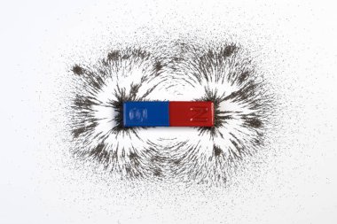 Red and blue bar magnet or physics magnetic with iron powder magnetic field on white background. Scientific experiment in science class in school. clipart
