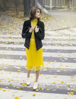 Sonbahar şehir sokak, yaya geçidi üzerinde sarı elbiseli genç kadın sezon sonbahar