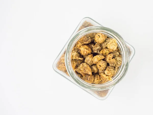 Dried chrysanthemum flowers in Bottle on white background — Stock Photo, Image