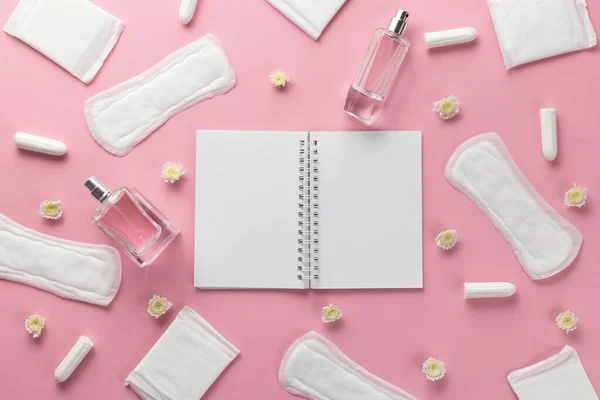 Tampons, feminine sanitary pads and empty paper on a pink background. Hygienic care on critical days. menstrual cycle. Caring for womens health. Monthly protection. Flat lay, top view, copy space.