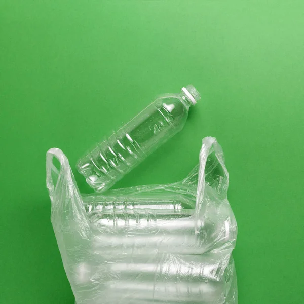 Composition of plastic waste pollution. Sorting and recycling. Disposable plastic bottles for water. Ecological concept. Flat lay, top view, copy space.