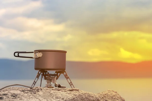 Cuisinière à gaz portable touristique pour préparer des plats chauds et du thé à l'air frais. Poêle portatif pour les activités de plein air, habituellement utilisé pour le camping, la randonnée et d'autres activités de plein air. Espace de copie Photo De Stock